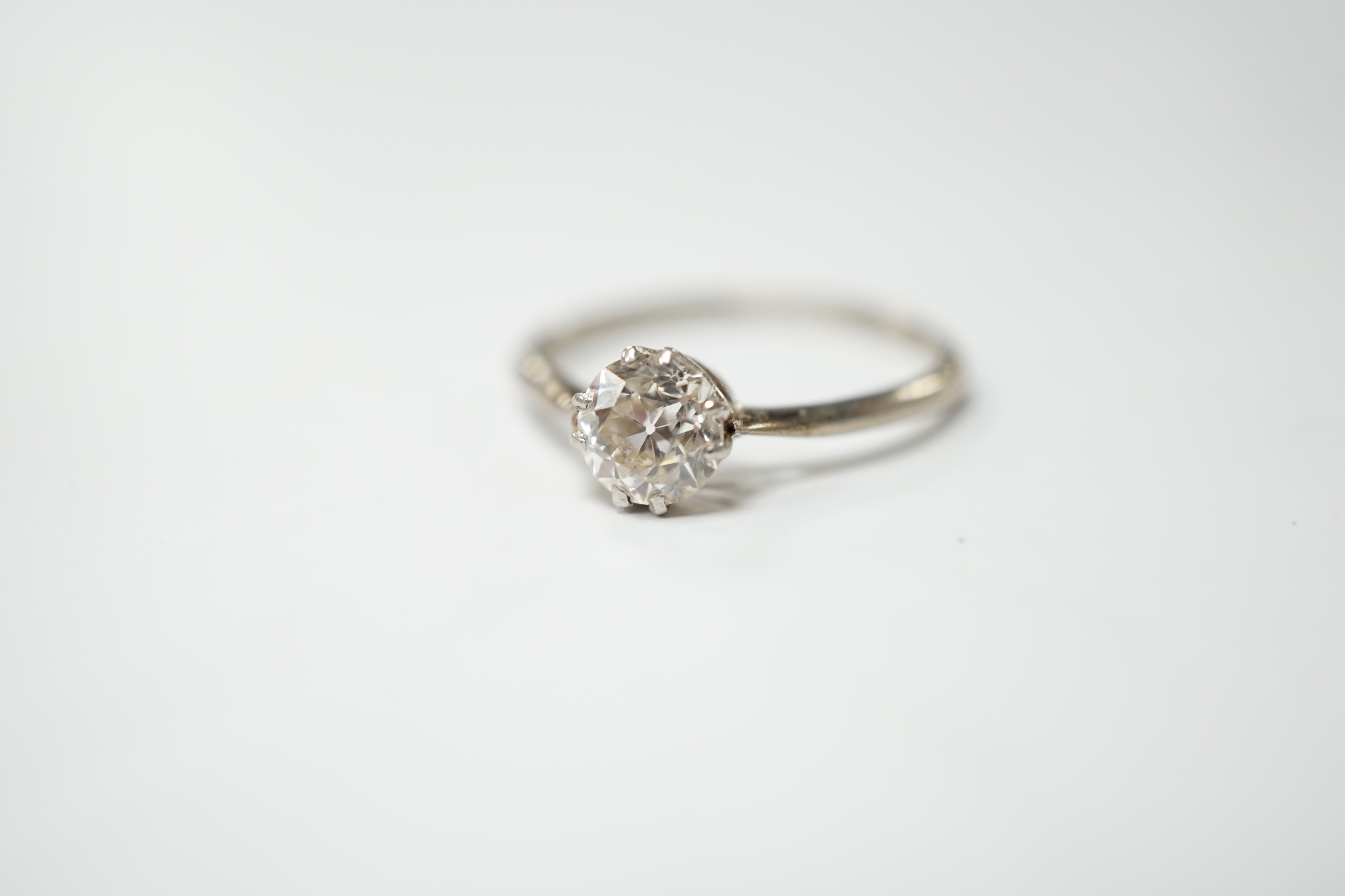 A white metal and solitaire diamond set ring, size O/P, gross weight 2.4 grams
